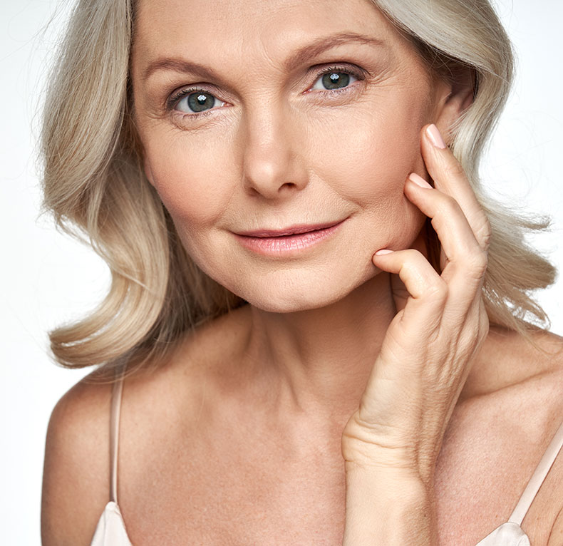 A woman posing with her hand on her face.