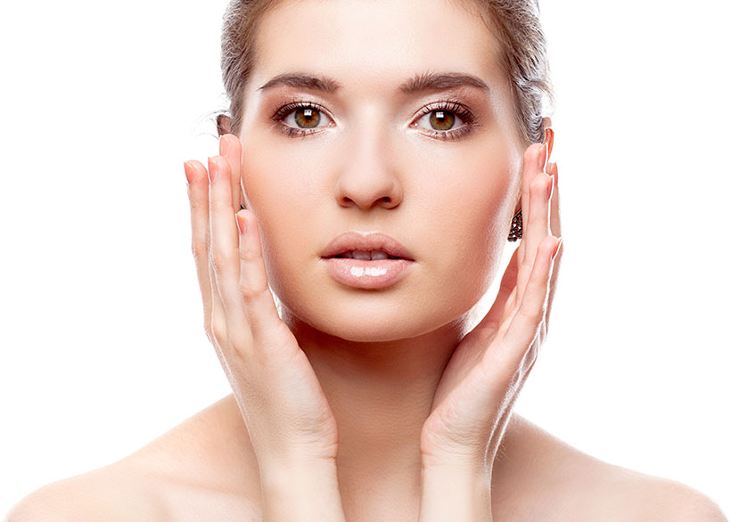 woman looking at camera with her hands on her cheeks